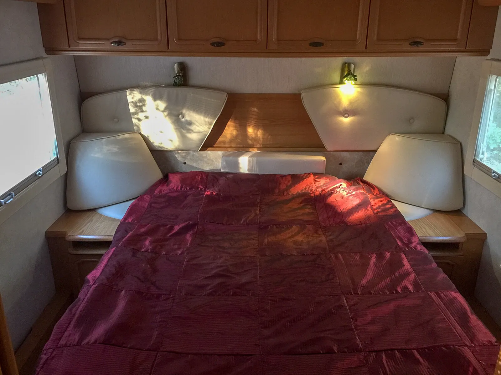 Doppelbett mit roter Tagesdecke